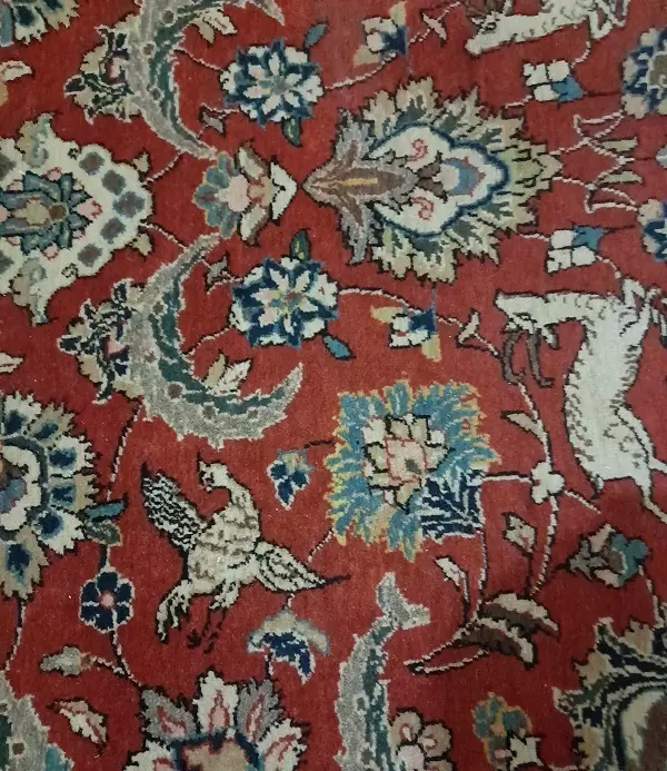 Antique rug with large hole expertly restored, seamless repair