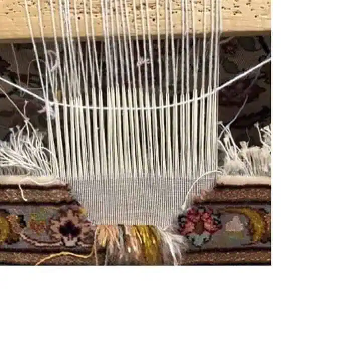Restoration in progress: Expert repairing a hole on an antique Oriental Persian rug