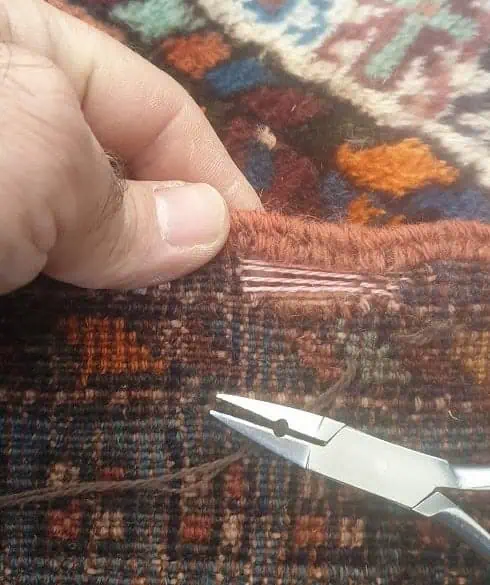 Oriental rug restoration service by a skilled artisan , a hole repair.