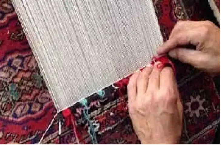 A reparman at work on repairing oriental rug