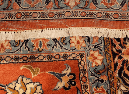Beautifully restored Persian rug showing no sign of previous hole damage after professional re-weaving.