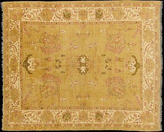 Oushak Carpet: Antique Reproduction All-Over Design An antique rug with a yellow background.